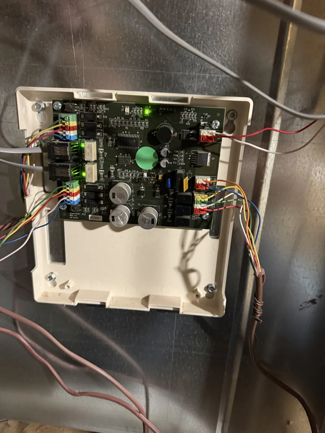 Open HVAC control board with color coded low voltage wiring